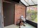 Screened patio with brick wall and propane tanks at 5123 Picadilly Circus Ct # 2, Orlando, FL 32839
