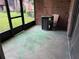 The enclosed porch features a brick wall, concrete floor, and access to outdoor views at 5123 Picadilly Circus Ct # 2, Orlando, FL 32839