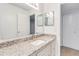 Well-lit bathroom with granite countertops, dual mirrors, and modern fixtures at 542 Orange Dr # 22, Altamonte Springs, FL 32701