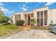 Exterior view of a two-story condo building with covered walkways and lush landscaping at 542 Orange Dr # 22, Altamonte Springs, FL 32701
