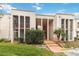 A two-story condo building featuring covered walkways and vibrant, green landscaping at 542 Orange Dr # 22, Altamonte Springs, FL 32701