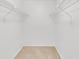 Walk-in closet with carpeted floor, white walls and shelving for optimal storage at 542 Orange Dr # 22, Altamonte Springs, FL 32701