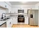 Bright kitchen with stainless steel appliances, granite countertops, and new cabinets at 542 Orange Dr # 22, Altamonte Springs, FL 32701