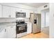 Modern kitchen with stainless steel appliances, granite countertops, and wood flooring at 542 Orange Dr # 22, Altamonte Springs, FL 32701