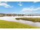 Scenic lake view with grassy shoreline and a clear, blue sky at 542 Orange Dr # 22, Altamonte Springs, FL 32701