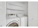 Convenient laundry area with washer, dryer, and built-in shelves for storage solutions at 542 Orange Dr # 22, Altamonte Springs, FL 32701
