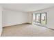 Spacious living room with carpeting and access to the outdoor patio at 542 Orange Dr # 22, Altamonte Springs, FL 32701