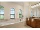 Elegant bathroom with large soaking tub and granite vanity at 5521 Hogan Ln, Winter Haven, FL 33884