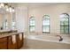 Elegant bathroom with large soaking tub and granite vanity at 5521 Hogan Ln, Winter Haven, FL 33884
