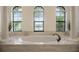 Elegant bathroom with large soaking tub and granite vanity at 5521 Hogan Ln, Winter Haven, FL 33884