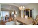 Spacious dining area with hardwood floors and views into the living room at 5521 Hogan Ln, Winter Haven, FL 33884