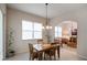 Bright dining room with wood table and chairs, adjacent to the kitchen at 5521 Hogan Ln, Winter Haven, FL 33884