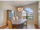 Formal dining room with hardwood floors, chandelier, and large window at 5521 Hogan Ln, Winter Haven, FL 33884
