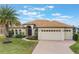 One-story house with a light brown roof and a brick driveway at 5521 Hogan Ln, Winter Haven, FL 33884