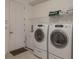 Laundry room with washer, dryer, and shelving at 5521 Hogan Ln, Winter Haven, FL 33884