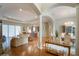 Open living space with hardwood floors, high ceilings, and a view of the kitchen at 5521 Hogan Ln, Winter Haven, FL 33884