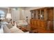Living room with hardwood floors, two sofas, and a large wooden cabinet at 5521 Hogan Ln, Winter Haven, FL 33884