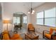 Relaxing sitting area, featuring orange couches and a view to the dining area at 5521 Hogan Ln, Winter Haven, FL 33884