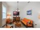 Cozy sitting area with orange couches and a flat-screen TV at 5521 Hogan Ln, Winter Haven, FL 33884