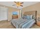 Spacious bedroom with striped bedding and ceiling fan at 570 Orange Dr # 54, Altamonte Springs, FL 32701