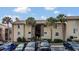 Condo building with parking lot and palm trees at 570 Orange Dr # 54, Altamonte Springs, FL 32701