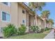 Tan multi-unit building with palm trees and lush landscaping at 570 Orange Dr # 54, Altamonte Springs, FL 32701