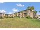 Condo building with grassy lawn and palm trees at 570 Orange Dr # 54, Altamonte Springs, FL 32701