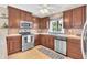 Updated kitchen with stainless steel appliances and wood cabinets at 570 Orange Dr # 54, Altamonte Springs, FL 32701