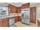 Updated kitchen with stainless steel appliances and wood cabinets at 570 Orange Dr # 54, Altamonte Springs, FL 32701