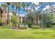 Community pool surrounded by palm trees and lawn at 570 Orange Dr # 54, Altamonte Springs, FL 32701