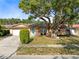 Ranch style home with mature landscaping and a two-car garage at 719 Dawson Ave, Orlando, FL 32825