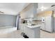 Galley kitchen with stainless steel appliances and view to the living room at 719 Dawson Ave, Orlando, FL 32825