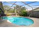 Refreshing kidney-shaped pool under a screened patio at 719 Dawson Ave, Orlando, FL 32825