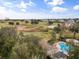 Resort-style pool and lush landscaping with golf course in the background at 7703 Heritage Crossing Way # 302, Reunion, FL 34747