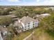 Condo building's exterior and surrounding landscape shown in this aerial view at 7703 Heritage Crossing Way # 302, Reunion, FL 34747