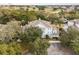 Aerial view of a condo building with a golf course in the background at 7703 Heritage Crossing Way # 302, Reunion, FL 34747
