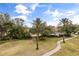 Community features lush landscaping, walking paths and a pool at 7703 Heritage Crossing Way # 302, Reunion, FL 34747