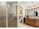 Bathroom features a walk-in shower, toilet and a wood vanity with granite countertop at 7703 Heritage Crossing Way # 302, Reunion, FL 34747
