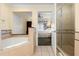 Bathroom features a soaking tub, walk-in shower, and updated vanity at 7703 Heritage Crossing Way # 302, Reunion, FL 34747