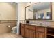 Bathroom with granite countertop, large mirror, and updated fixtures at 7703 Heritage Crossing Way # 302, Reunion, FL 34747