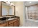 Bathroom with granite vanity and a tub shower combination at 7703 Heritage Crossing Way # 302, Reunion, FL 34747
