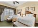 Two twin beds in a bright bedroom with window seating at 7703 Heritage Crossing Way # 302, Reunion, FL 34747