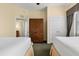 Bedroom with twin beds, wooden cabinet, and carpet flooring at 7703 Heritage Crossing Way # 302, Reunion, FL 34747