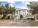 Two-story building exterior with parking and landscaping at 7703 Heritage Crossing Way # 302, Reunion, FL 34747