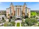 Luxury high-rise building with palm trees and manicured landscaping at 7703 Heritage Crossing Way # 302, Reunion, FL 34747