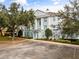 Building exterior with parking and landscaping at 7703 Heritage Crossing Way # 302, Reunion, FL 34747