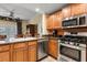 Kitchen with island, stainless steel appliances, and granite countertops at 7703 Heritage Crossing Way # 302, Reunion, FL 34747