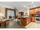 Open concept kitchen and living area with island, stainless steel appliances, and comfortable seating at 7703 Heritage Crossing Way # 302, Reunion, FL 34747