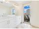 Modern bathroom with double vanity, marble floors, and access to balcony at 100 S Eola Dr # 1201, Orlando, FL 32801