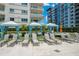 Poolside relaxation area with shaded cabanas and lounge chairs at 100 S Eola Dr # 1201, Orlando, FL 32801